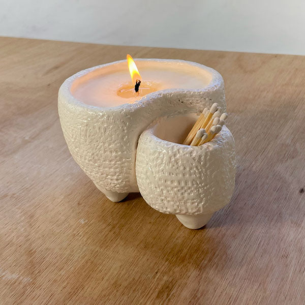 Sculpd handmade creation - Ceramic candle holder with a lit candle and matches