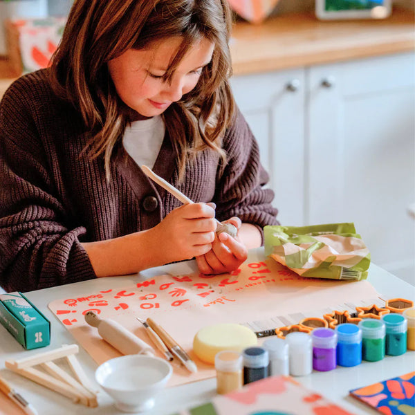 A kid enjoying his pottery kit