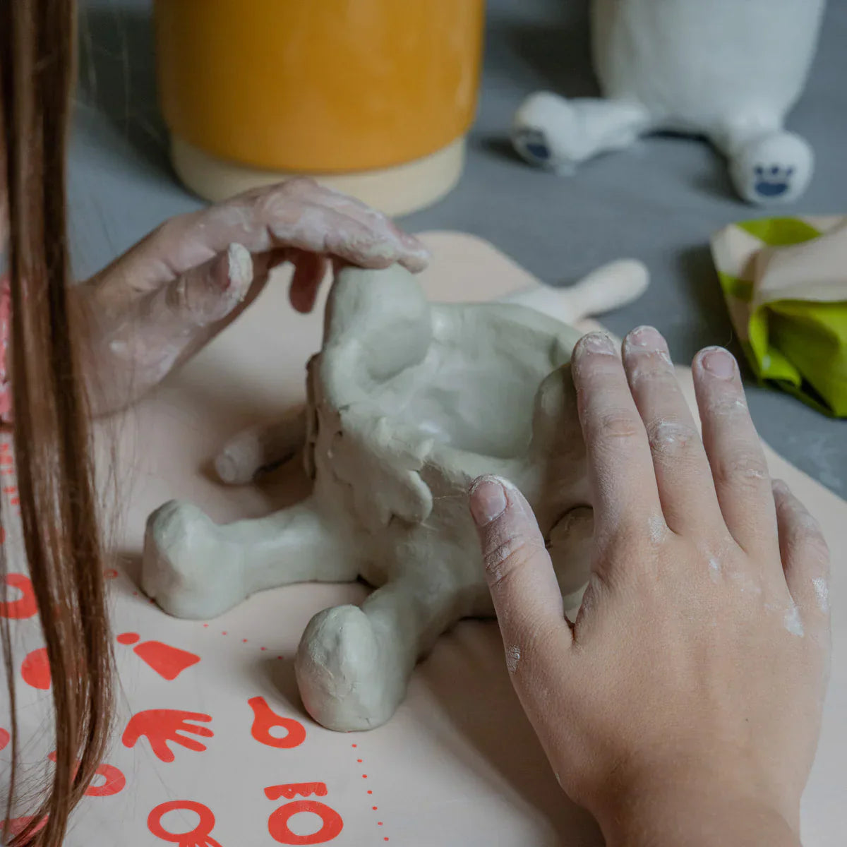 A young kid sculpting a cute diy project with her Sculpd kids pottery kit