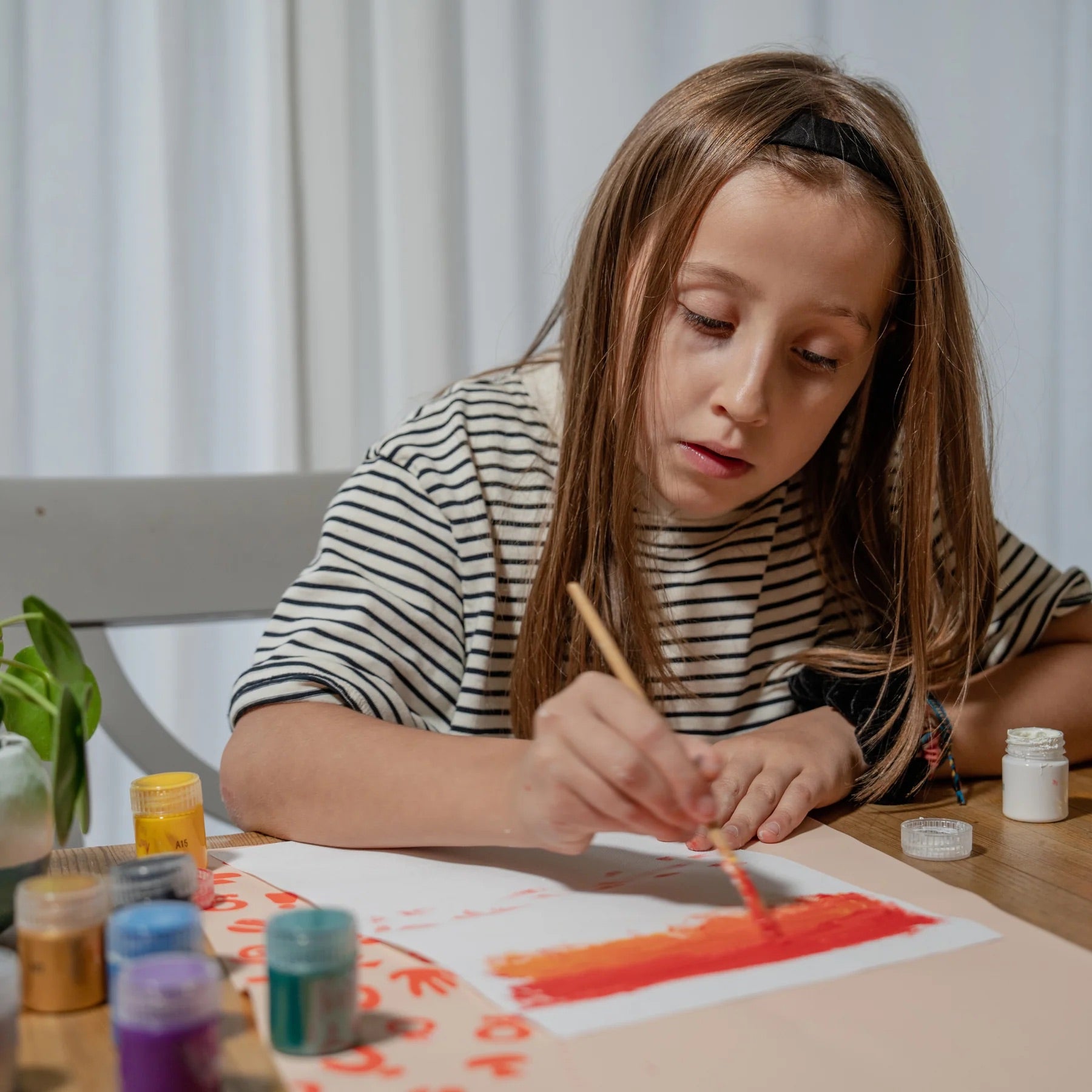 A young girl having fun with her Sculpd canvas painting kit