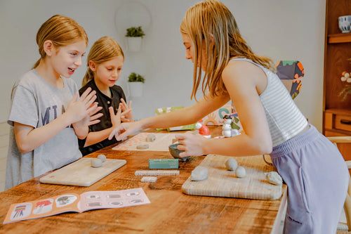 Three children enjoying Sculpd kids pottery kit