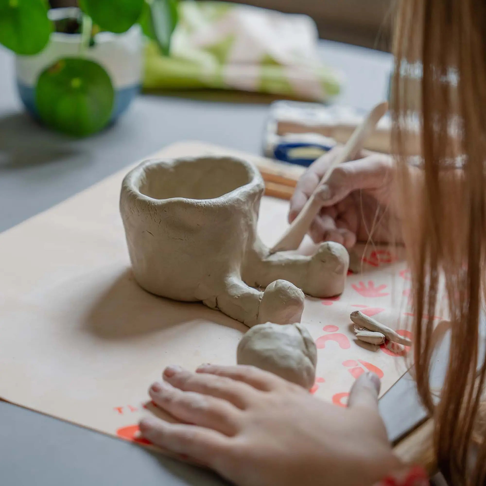 Sculpting pottery with Sculpd kids mess mat